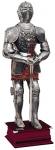 Armours - Medieval Armour - Medieval Armour (Spanish) - The armour has been made in polished steel, characterized by floreal etchings on some parts and elaborated relief figures on others that make this model particularly rich. Provided with an arabesqued fabric gown.
