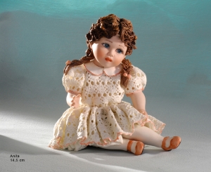 Sculpture depicting little girl sitting, Anita, Sibania Porcelain Figurines - Porcelain sculpture depicting little girl sitting, Anita, height 14.5 cm (5.7 in).